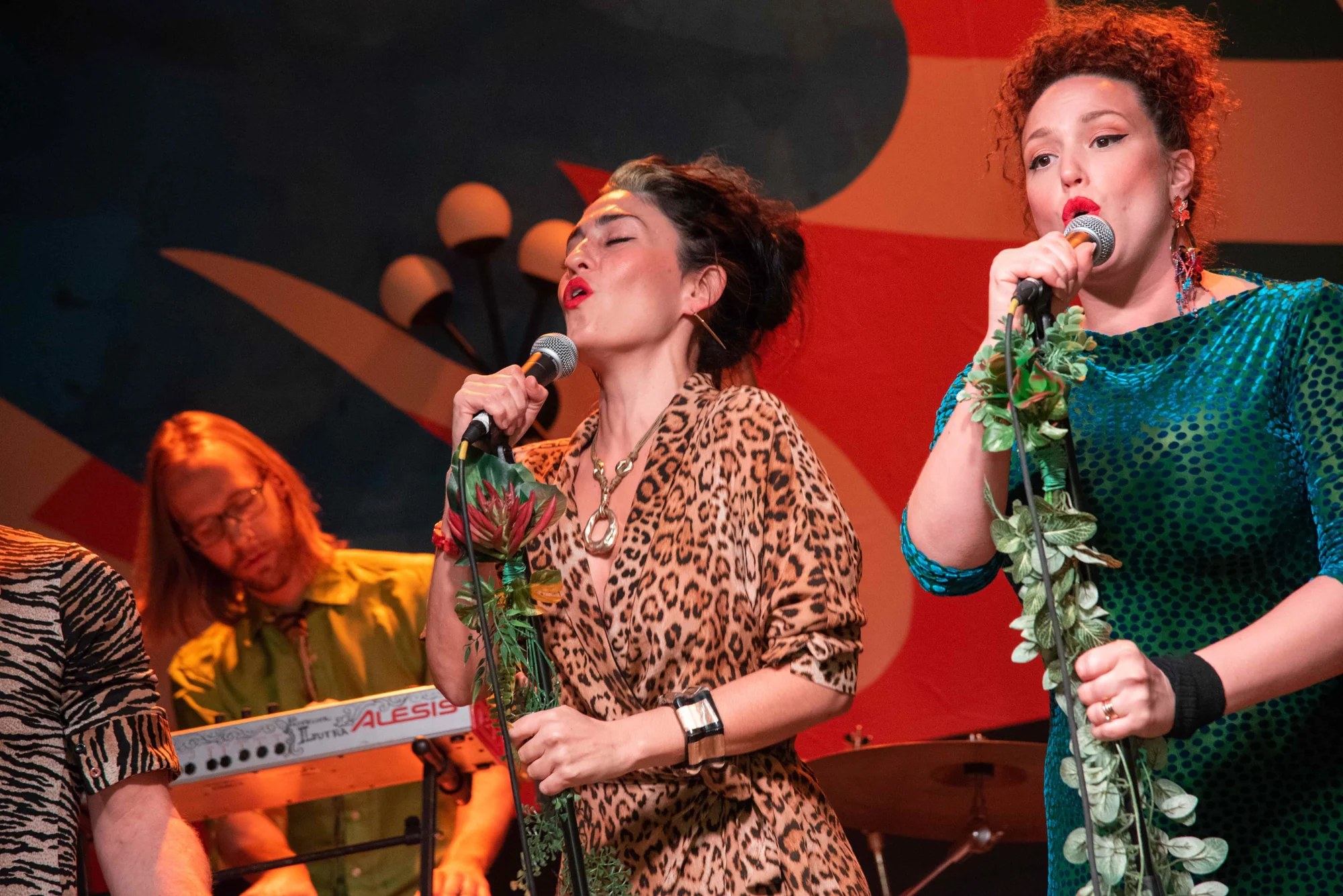 Two vocalists performing live on the Queen St. Fare stage.